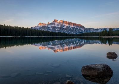 Calm lake against rocky mountains