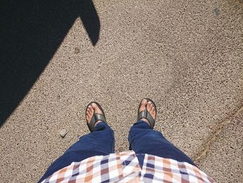 Low section of person standing on tiled floor