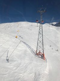 Ski lift over snow covered field