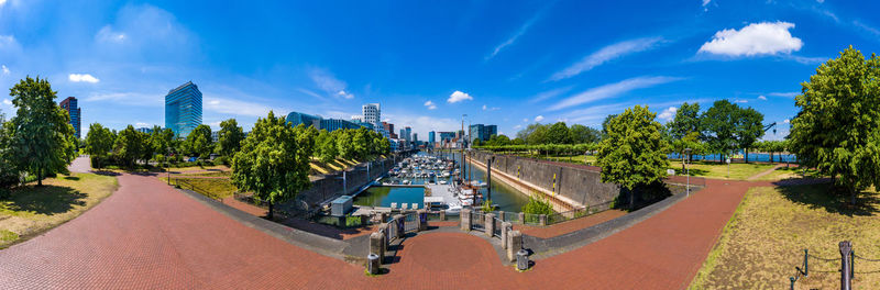 Panoramic view of city against cloudy sky