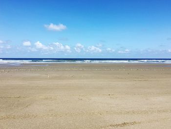 Scenic view of sea against blue sky