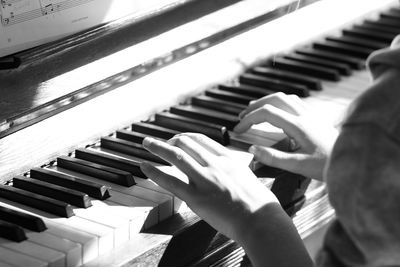 Close-up of hands playing piano