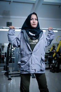 Portrait of young woman standing in gym