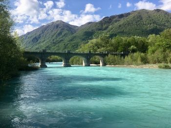 Arch bridge over river against sky