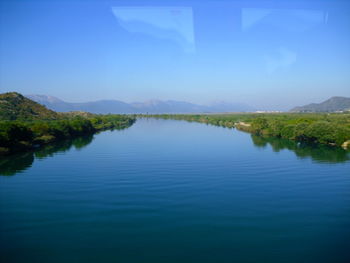 Scenic view of lake against blue sky