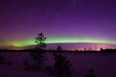 Scenic view of lake against sky at night