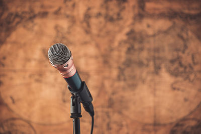 Close-up of microphone against wall