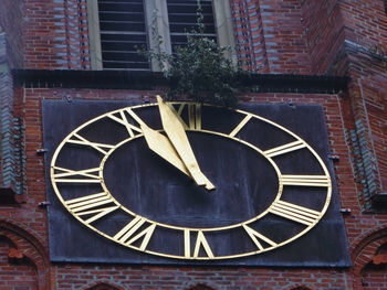 Low angle view of clock on old building