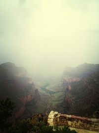 Scenic view of mountains against sky during foggy weather