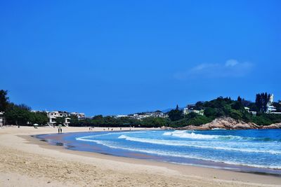 Scenic view of beach against clear blue sky