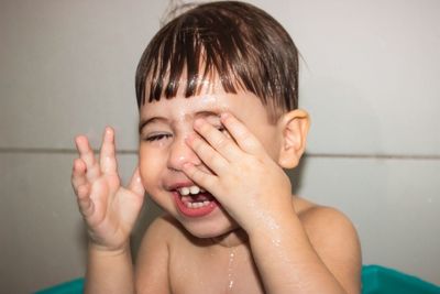 Portrait of shirtless boy in bathroom