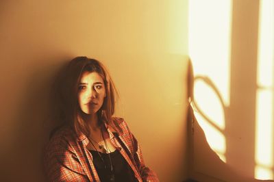 Portrait of beautiful young woman looking away at home