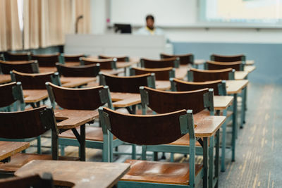 Empty chairs and tables in row