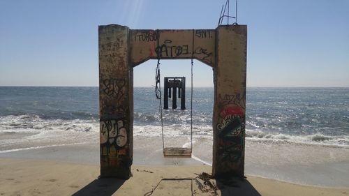 Lifeguard hut on beach against clear sky