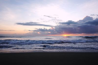 Scenic view of beach against sky during sunset