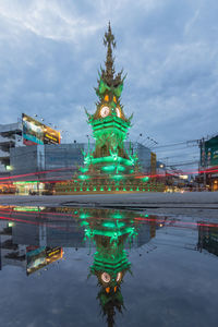 Illuminated building in city at dusk