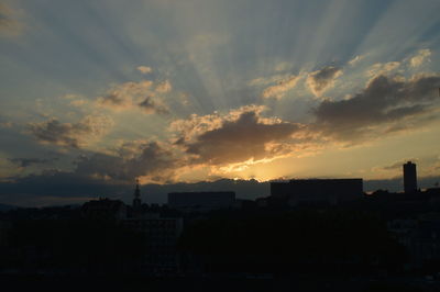 Silhouette cityscape against sky during sunset