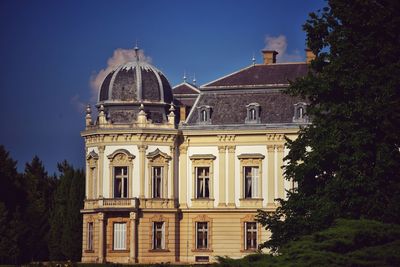 Low angle view of building against clear blue sky