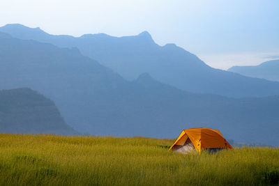 Scenic view of field against mountain range