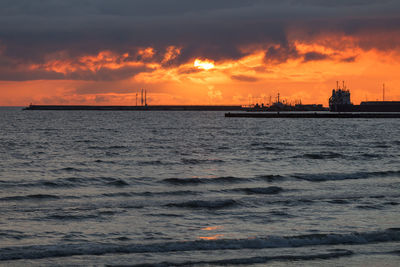 Scenic view of sea against orange sky