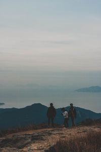 People standing on land against sky