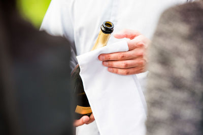 Close-up of man holding bottle