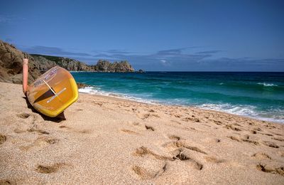 Scenic view of beach against blue sky