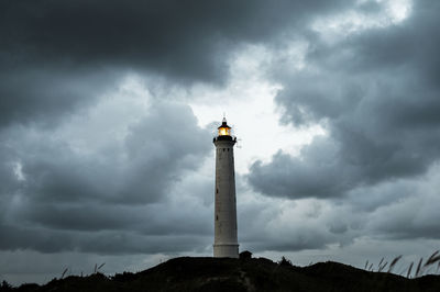 Lighthouse against cloudy sky