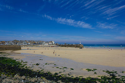 Scenic view of beach against blue sky