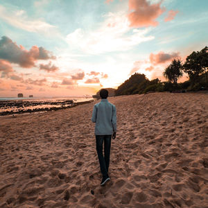 Rear view of man standing on beach