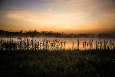 Scenic view of lake against sky during sunset