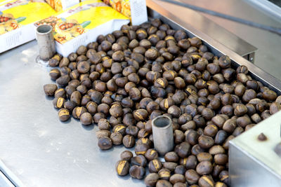 High angle view of roasted chestnuts for sale at market
