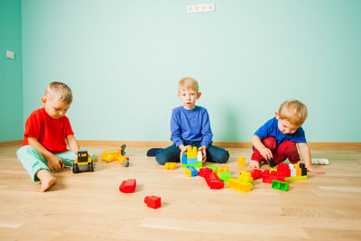 Boy playing with toy on floor