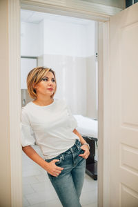 Portrait of a beautiful slender woman in the doorway of a bright medical office. the proprietress of