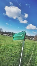 Scenic view of grassy field against cloudy sky