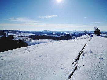 Scenic view of landscape against sky during winter