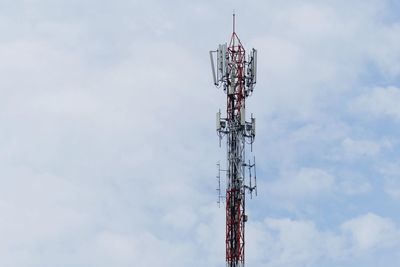 Low angle view of communications tower against sky