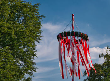 Low angle view of flags hanging against sky