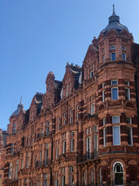 Low angle view of historical building against clear blue sky