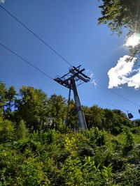 Low angle view of electricity pylon against sky