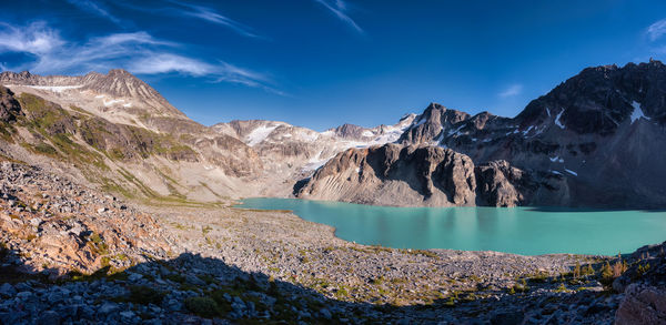 Panoramic view of lake and mountains against blue sky