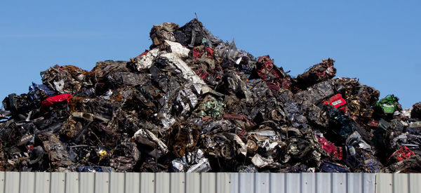 Panoramic view of cars stacked at junkyard