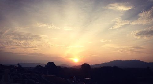 Scenic view of mountains against sky at sunset