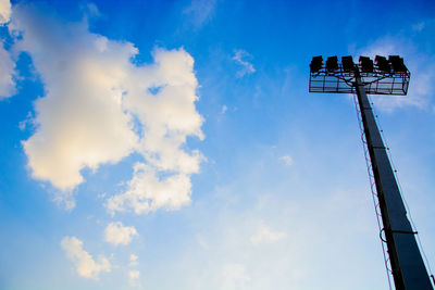 Low angle view of floodlight against blue sky