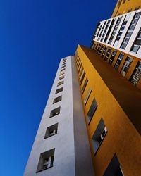 Low angle view of building against clear blue sky