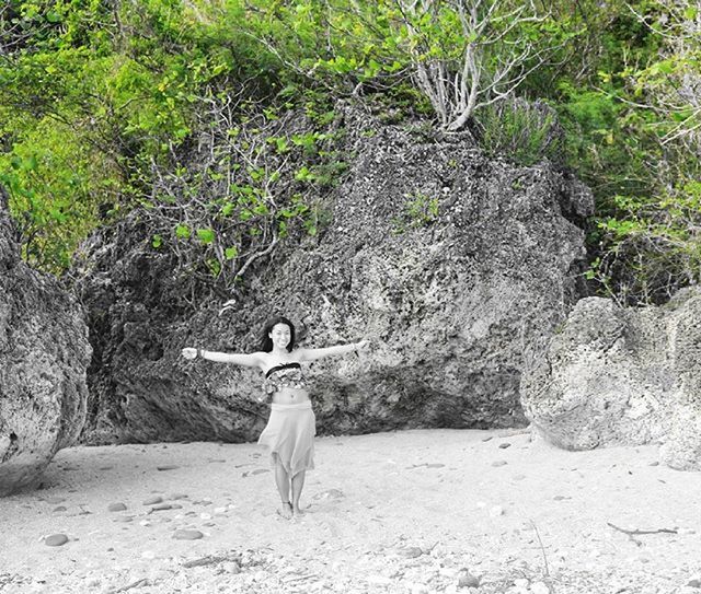 full length, lifestyles, leisure activity, casual clothing, rear view, tree, standing, walking, rock - object, sunlight, day, young adult, nature, side view, outdoors, plant, men, growth