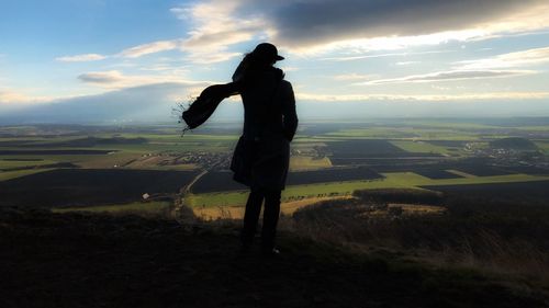 Woman standing on mountain against landscape