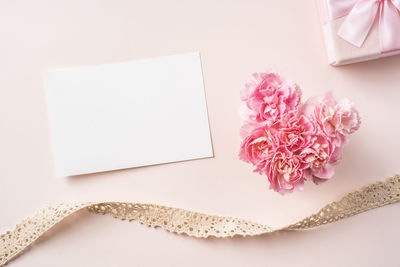 High angle view of pink flower on white table