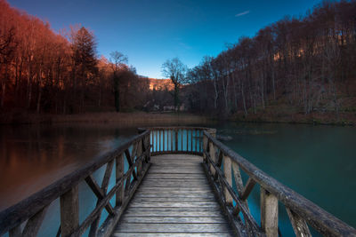 Pier over lake against sky