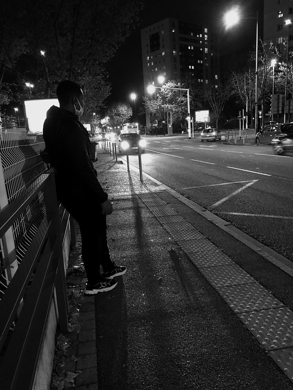 night, darkness, black, black and white, city, one person, monochrome, street, architecture, monochrome photography, white, illuminated, road, light, transportation, men, street light, full length, building exterior, built structure, city life, infrastructure, adult, lane, mode of transportation, lifestyles, person, city street, rear view, outdoors, standing, clothing